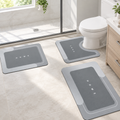 Gray 3-piece bath mat set laid out in a bathroom